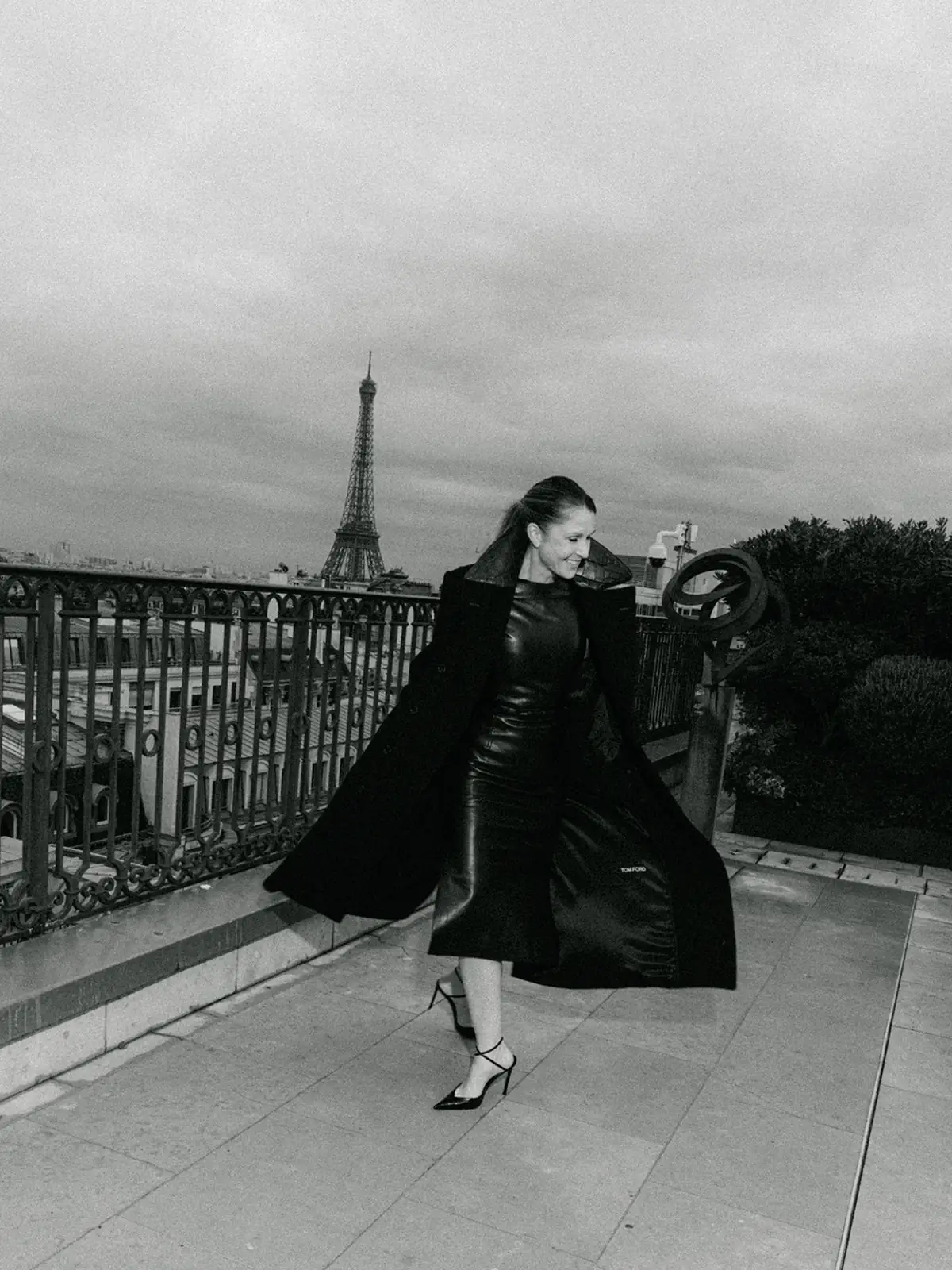 Black and white photograph of a coat moving across a Paris rooftop