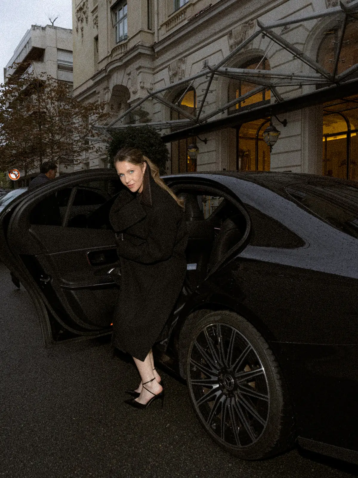 Fashion portrait beside a car outside the hotel