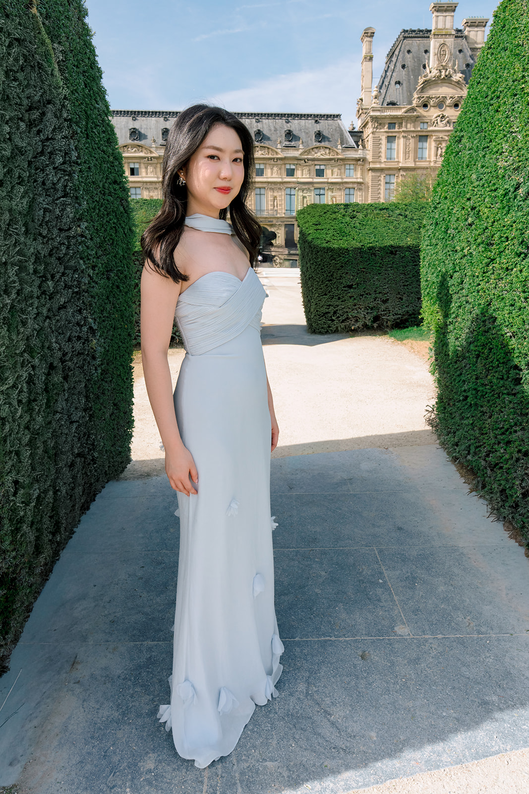 Editorial bridal portrait in a pale gown in the Louvre gardens in Paris