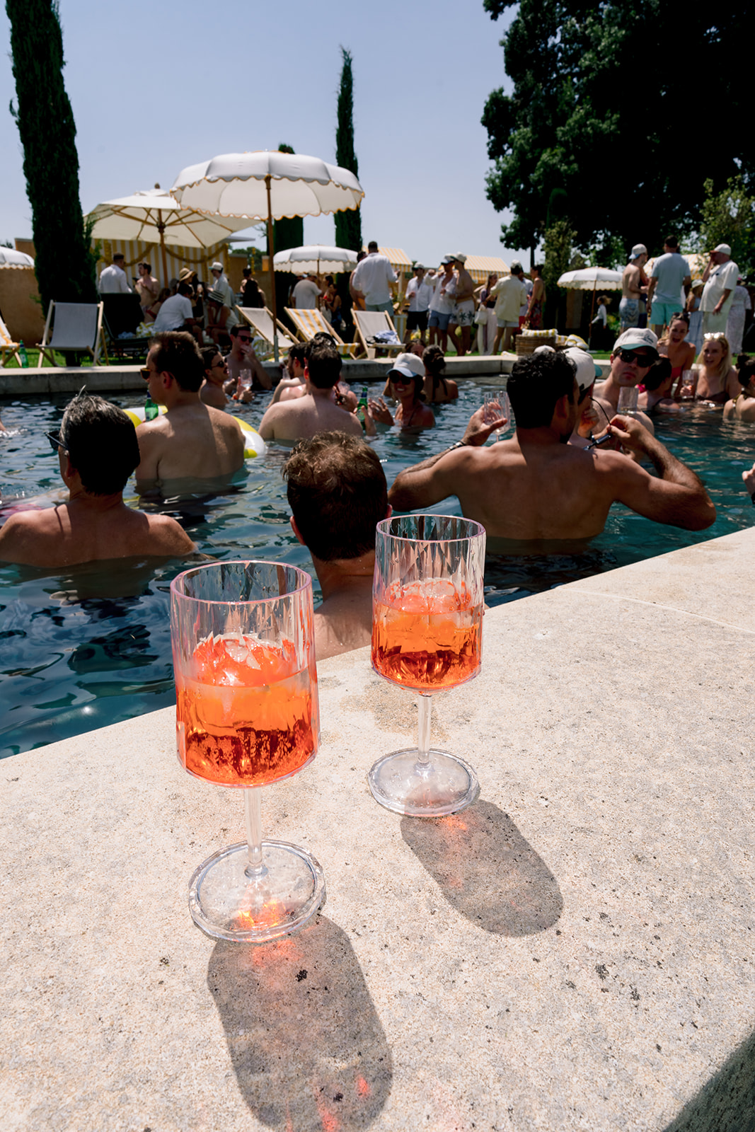 Guests celebrating in the pool during an opening-day destination wedding party in Provence