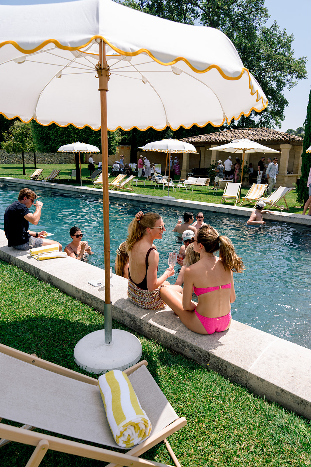 Wedding guests relaxing beside the pool during a destination wedding in Provence