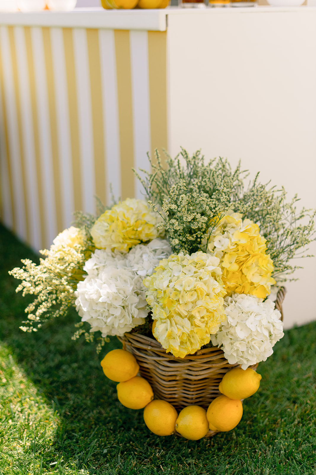 Yellow and white hydrangea floral decor with lemons for a wedding pool party