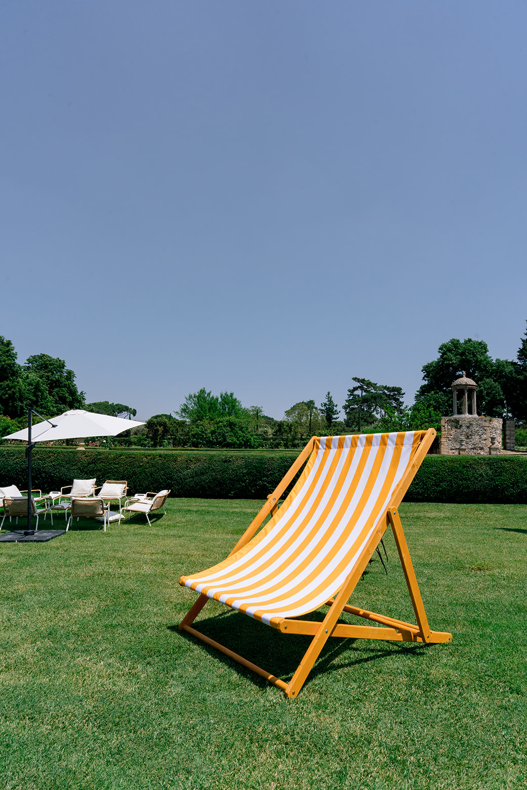 Yellow and white striped poolside lounger for a summer wedding party in Provence