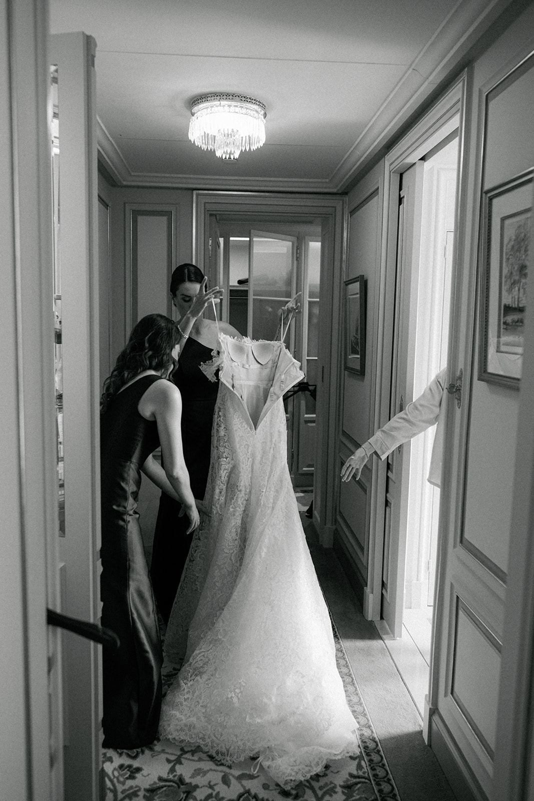 Final touches to the bride wedding dress in a Ritz Paris suite