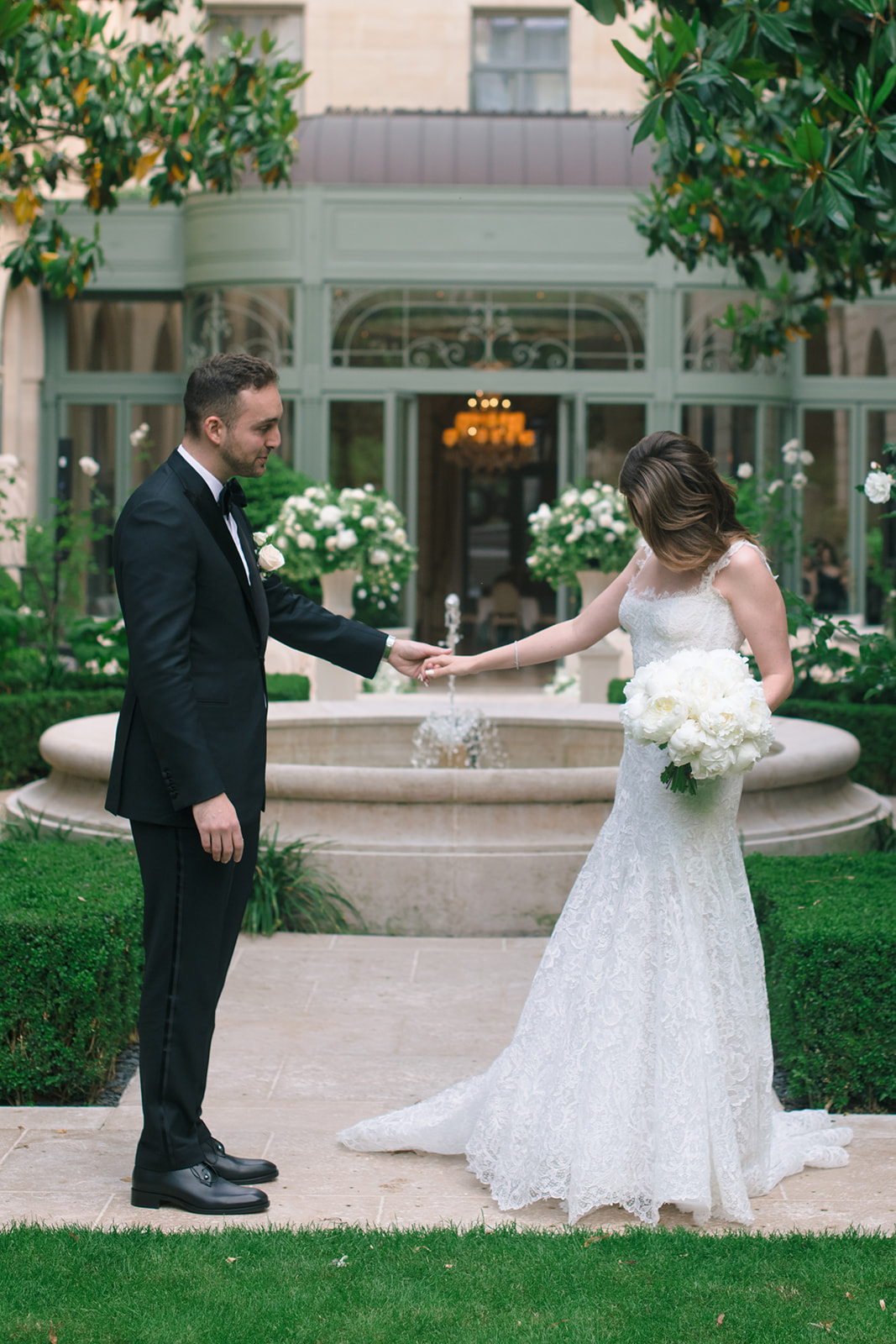 Bride and groom meeting for their first look in the Ritz Paris garden