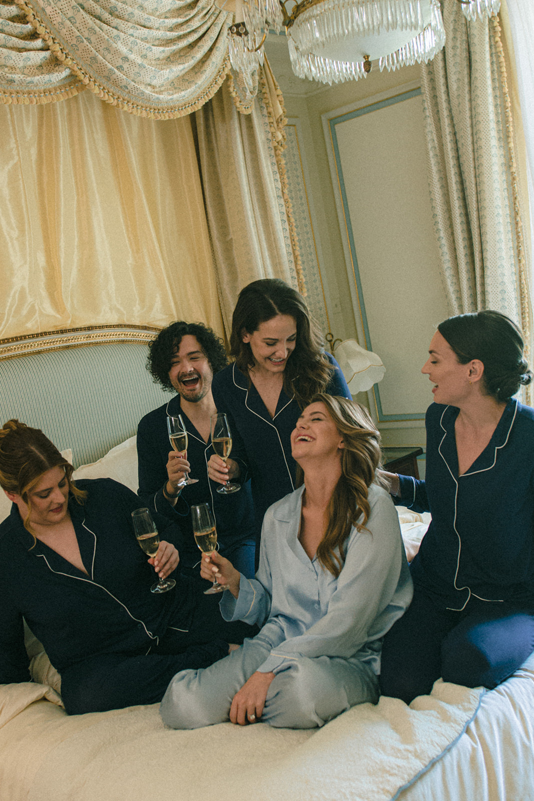 Bride having her makeup finished with bridesmaids in a Ritz Paris suite