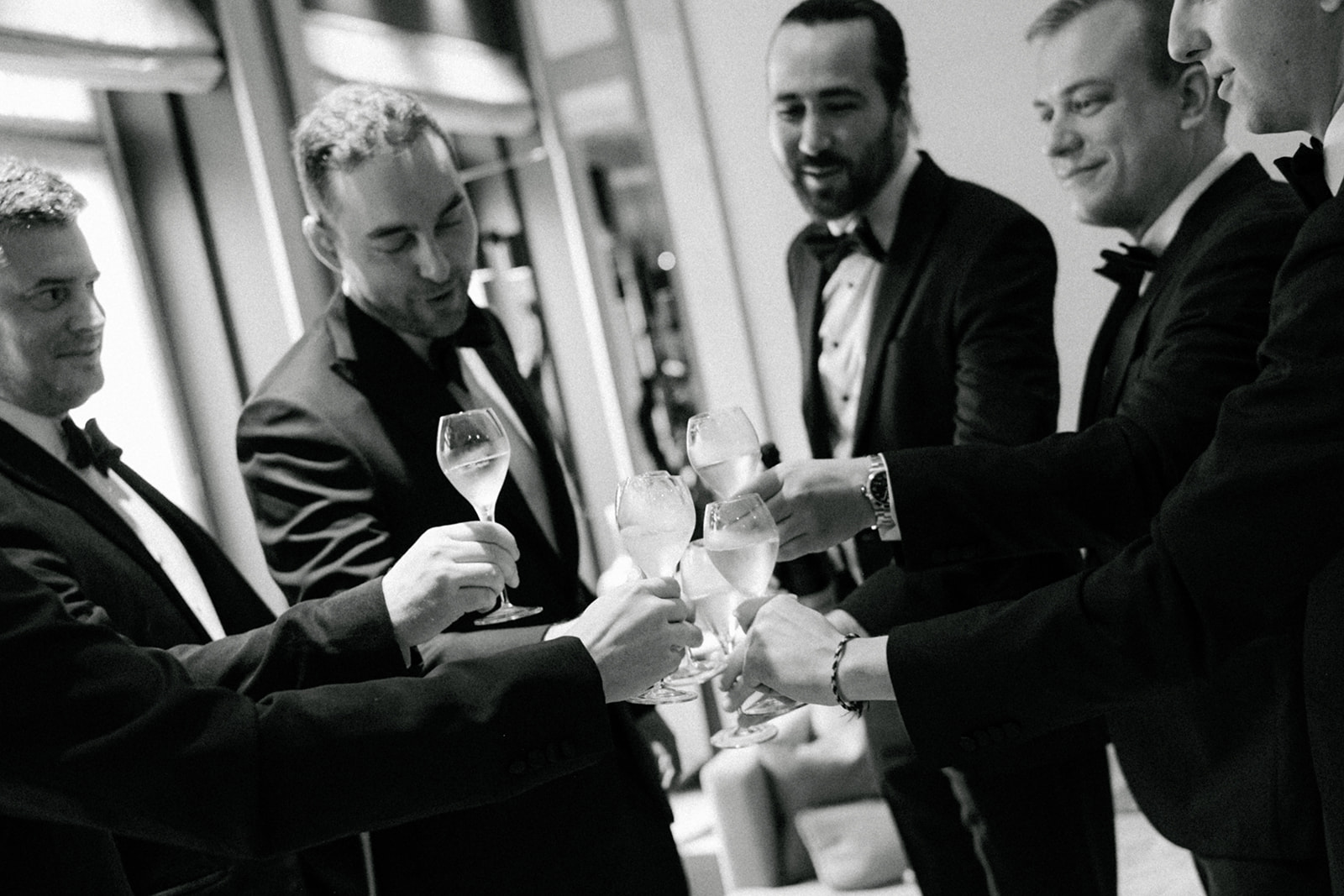 Groom and groomsmen laughing during wedding morning at the Ritz Paris