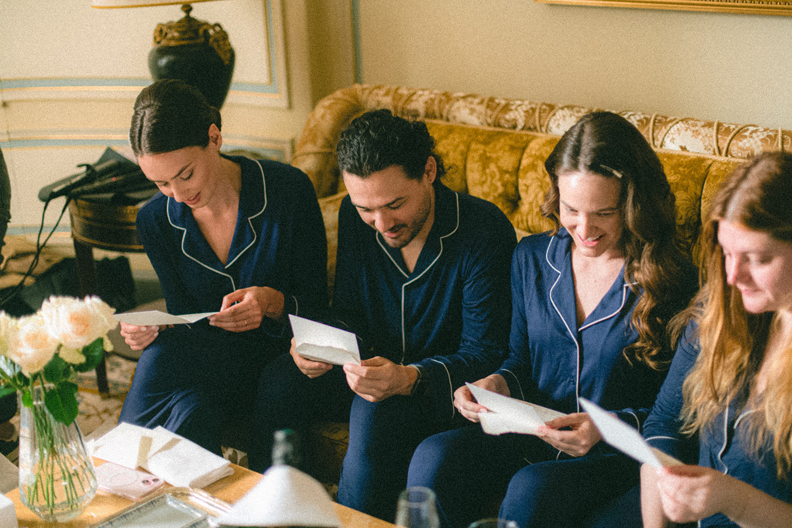 Groom and groomsmen reading personal notes in a Ritz Paris suite