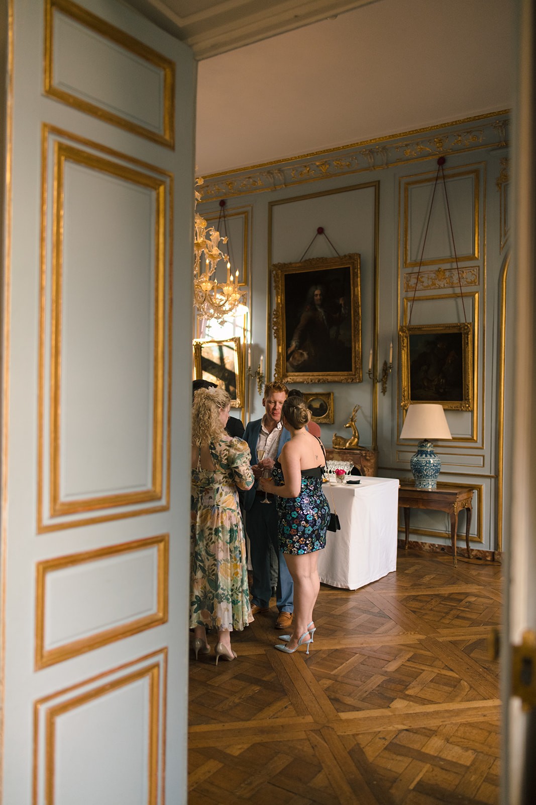 Guests gathering inside an ornate private Paris mansion during the welcome dinner