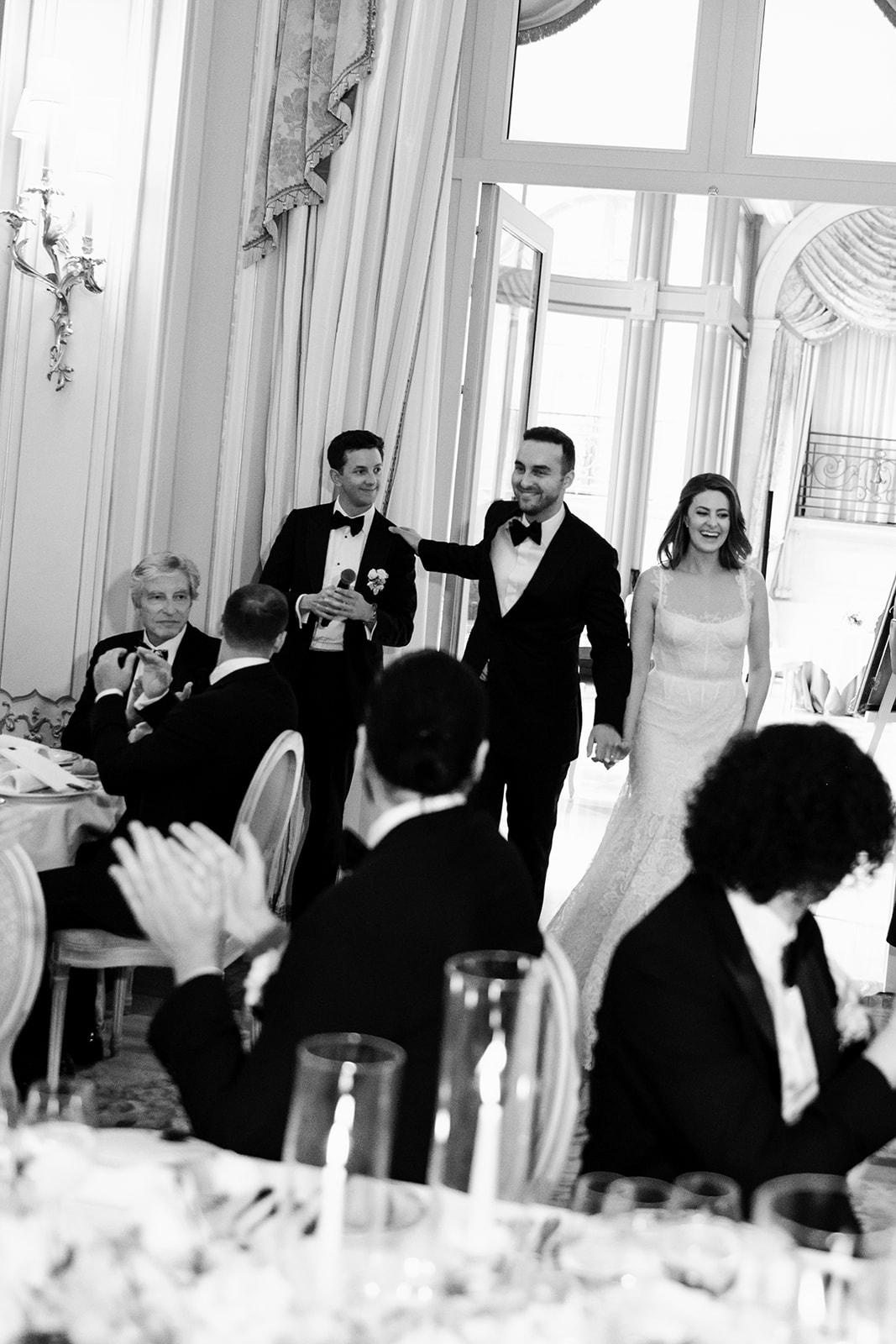 Wedding guests laughing together during dinner at the Ritz Paris