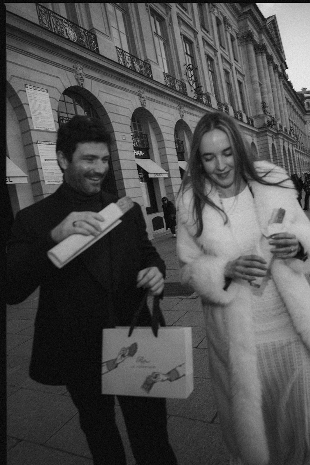Black-and-white film-inspired photograph of a couple walking on Rue Cambon