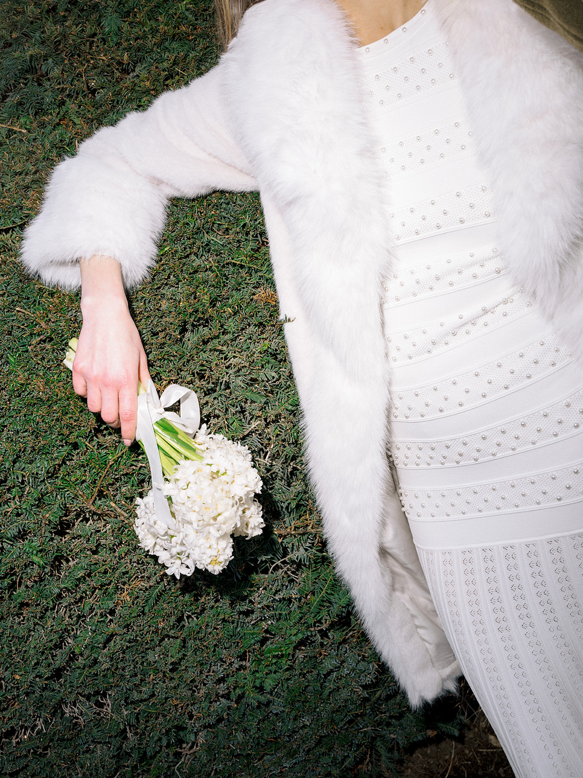 Editorial detail of white flowers and a fur coat in the Tuileries Garden