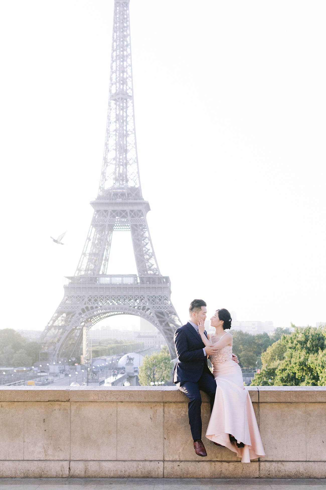Couple kissing in front of the Eiffel Tower 