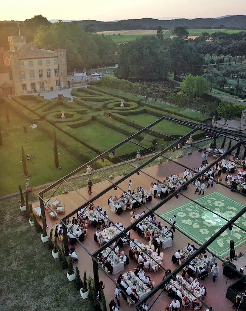 Aerial view of a wedding dinner installation in the formal gardens of Villa Baulieu