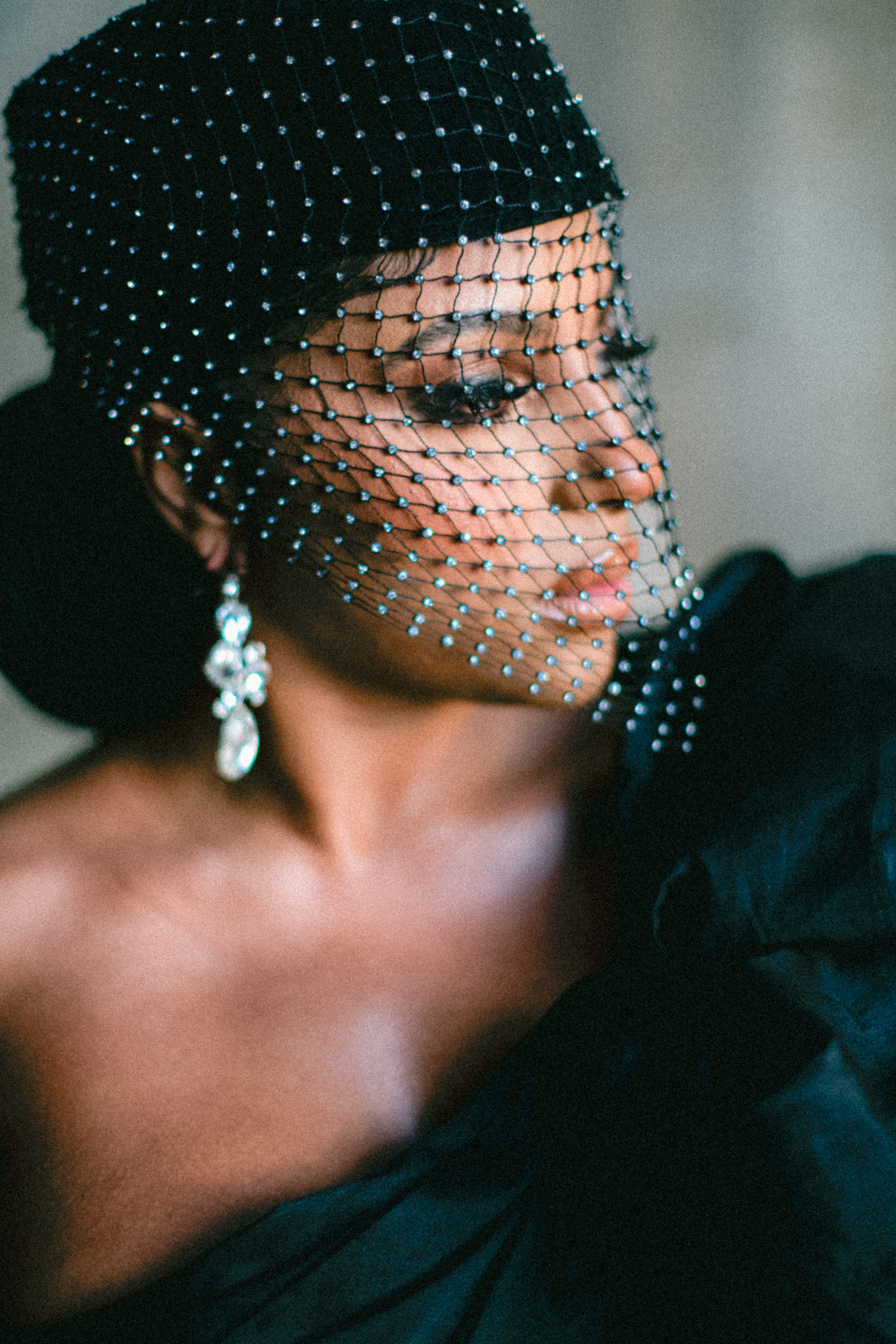 Editorial close-up portrait of Candice Craig wearing a crystal beaded veil in Paris