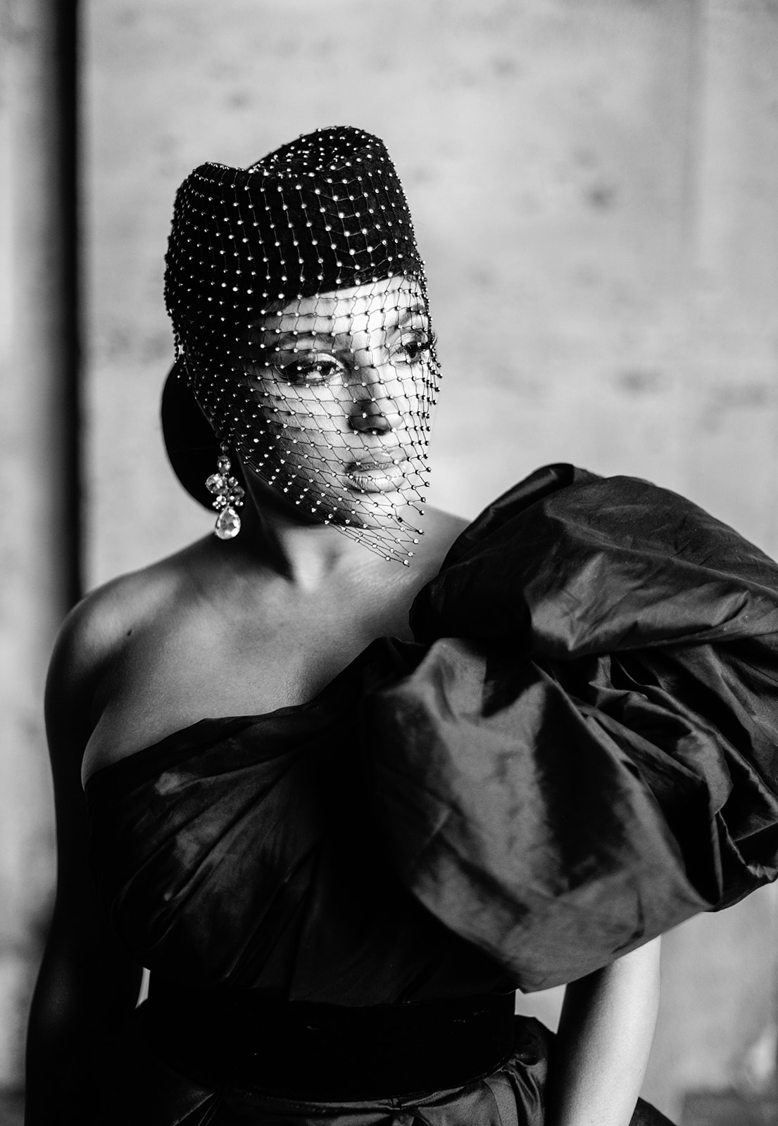 Black-and-white close portrait of Candice Craig wearing a crystal beaded veil in Paris