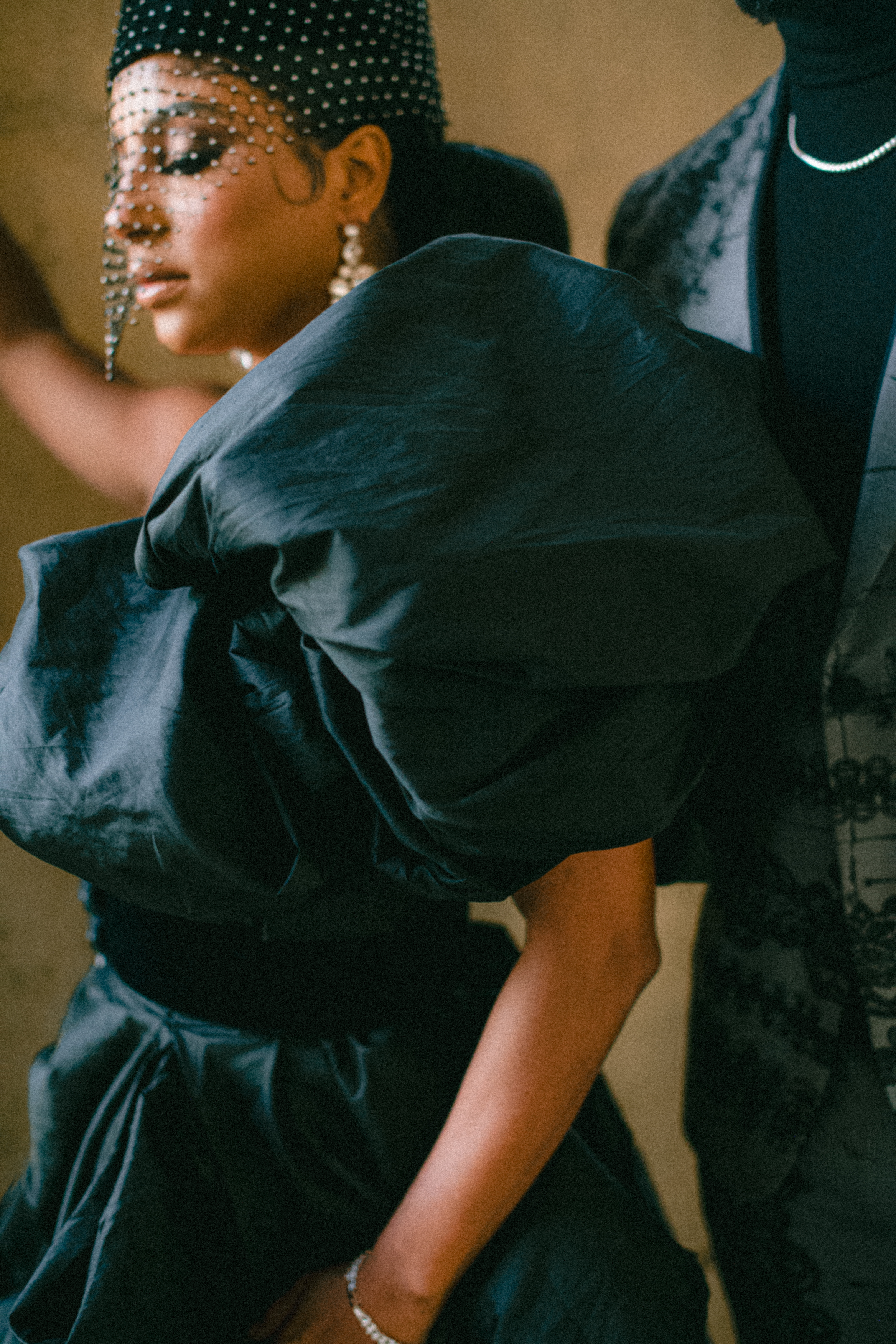 Profile portrait of Candice Craig in a sculptural black dress at the Louvre in Paris