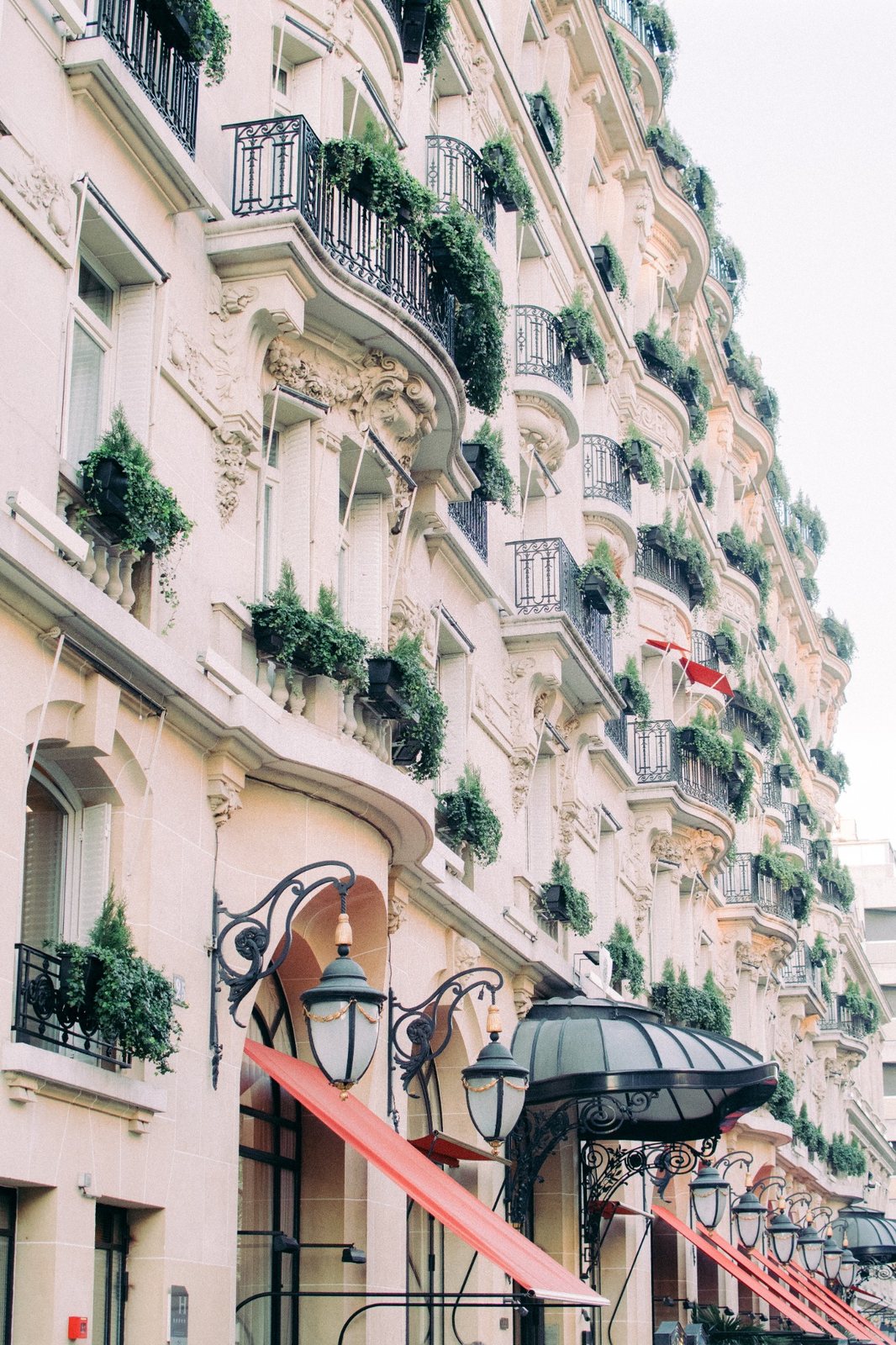 Hôtel Plaza Athénée exterior and red awnings on Avenue Montaigne in Paris