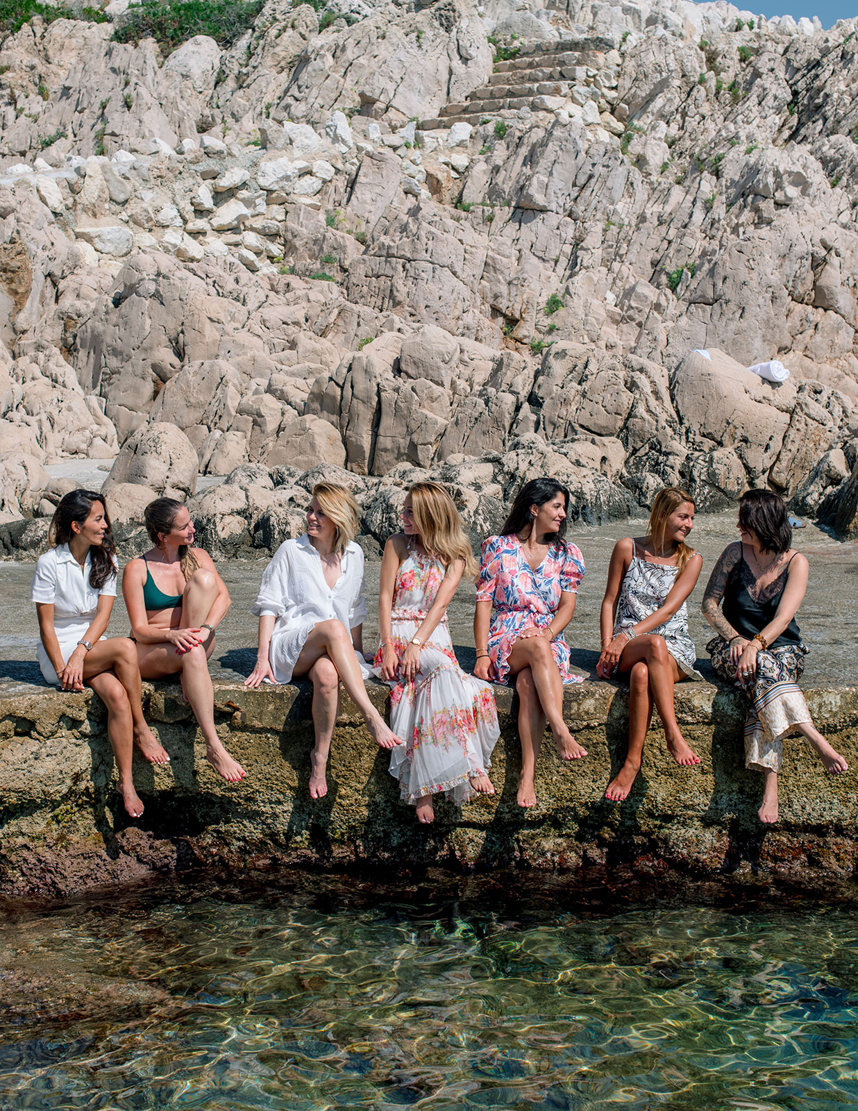 Wedding guests gathered beside the Mediterranean rocks at Saint-Jean-Cap-Ferrat