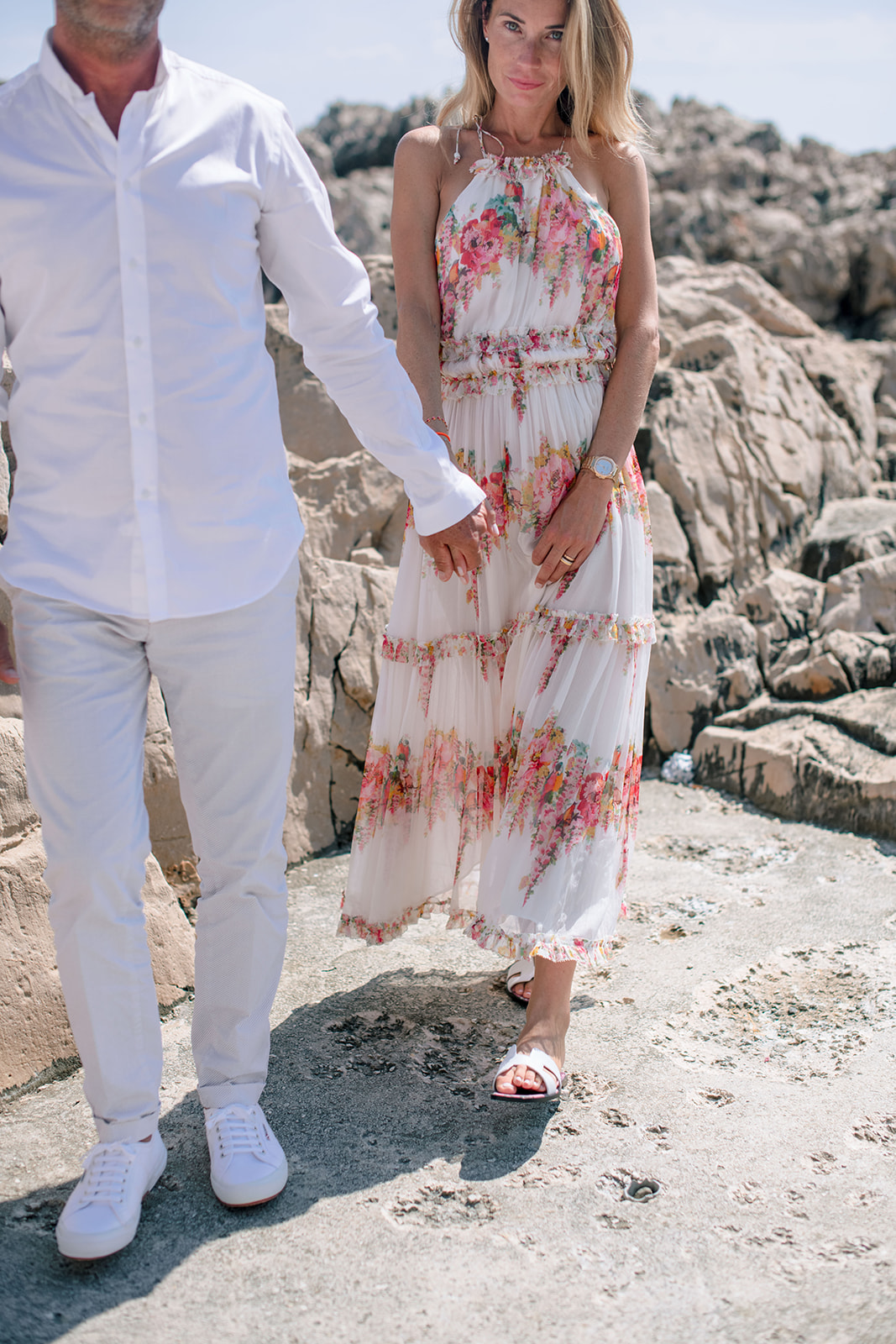 Wedding guests walking on the rocky shoreline of Saint-Jean-Cap-Ferrat