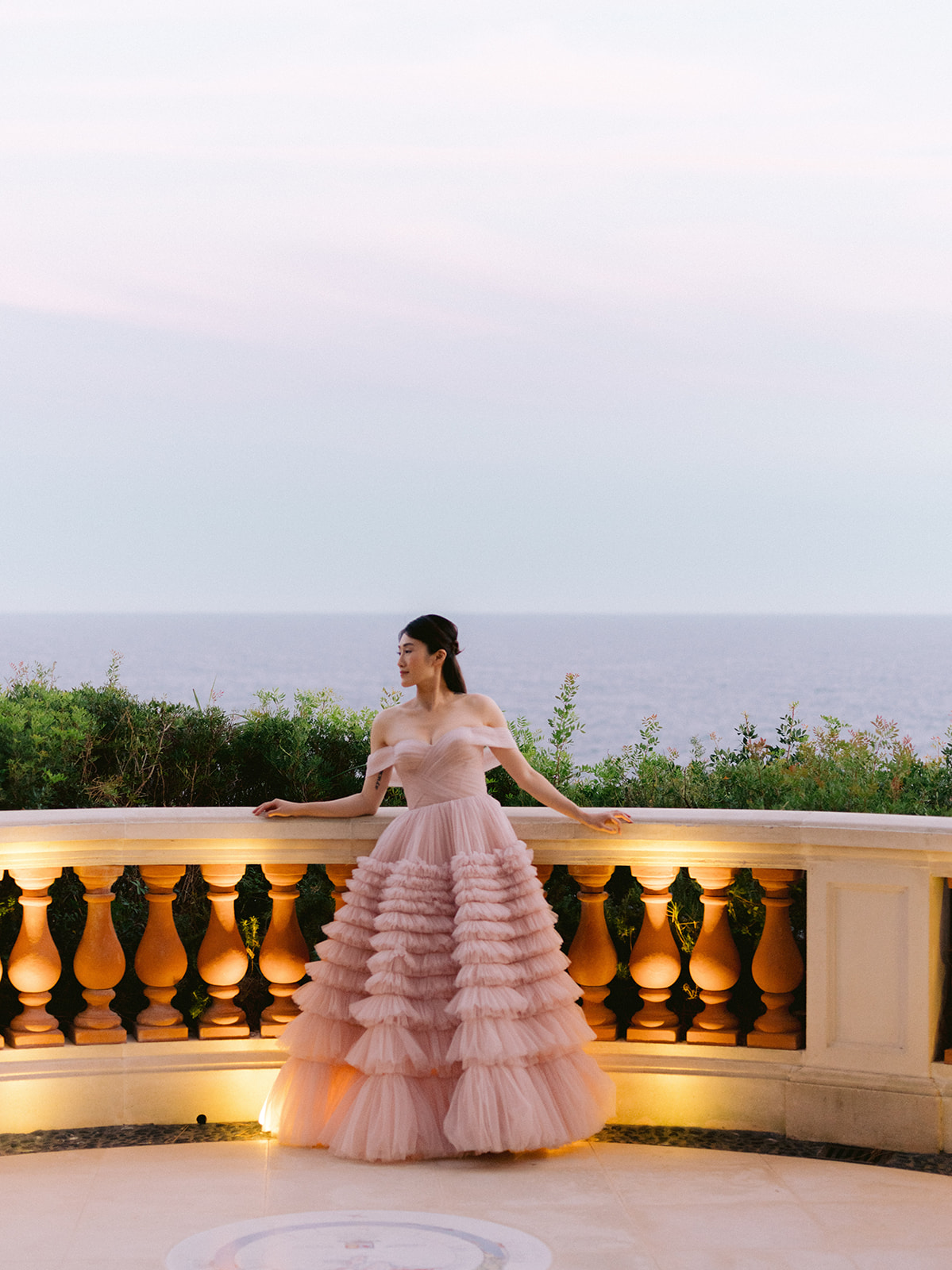 Pink evening gown on a sea-view terrace near Club Dauphin