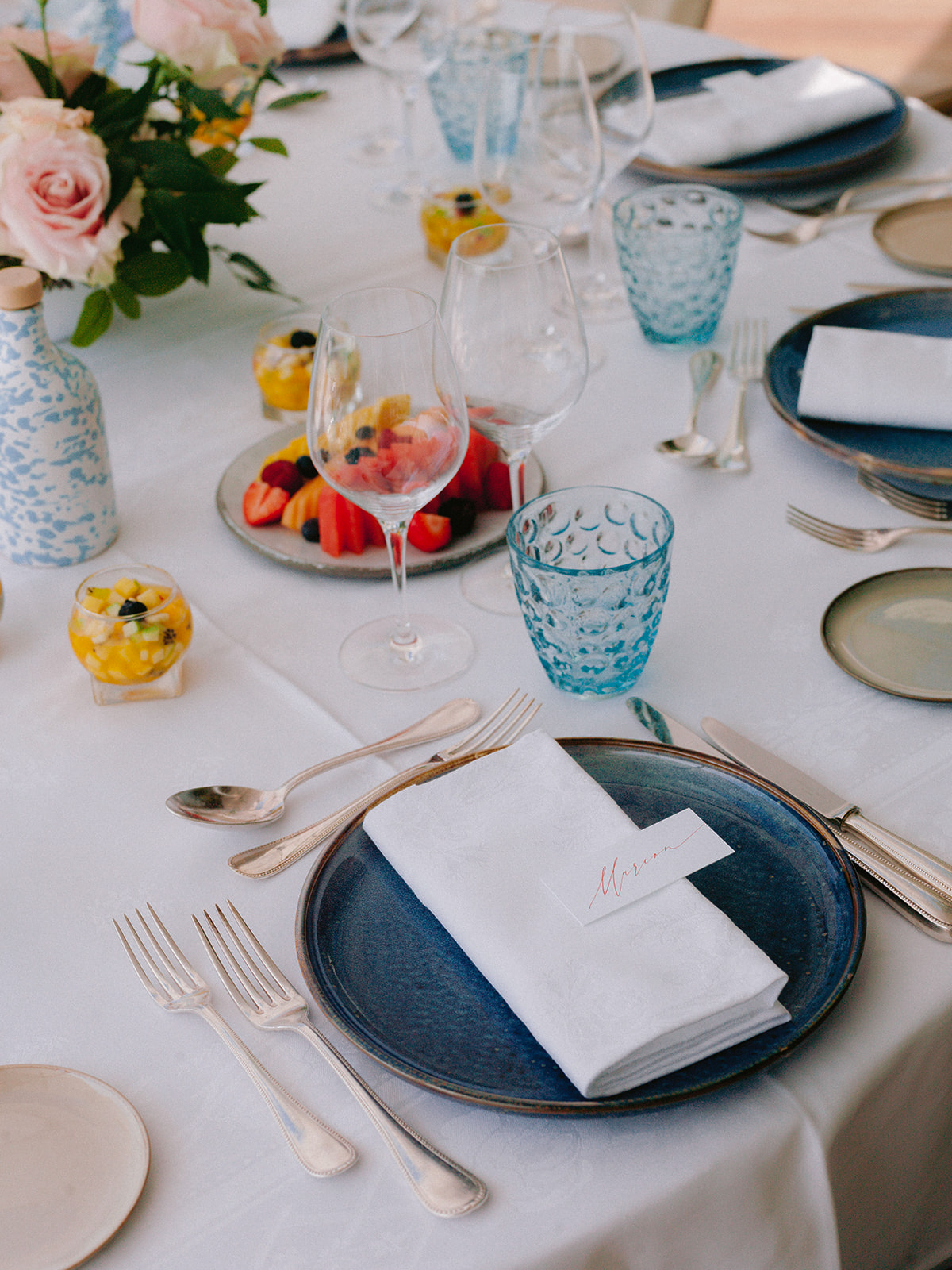 Blue tableware, fresh fruit and flowers prepared for a Club Dauphin farewell brunch