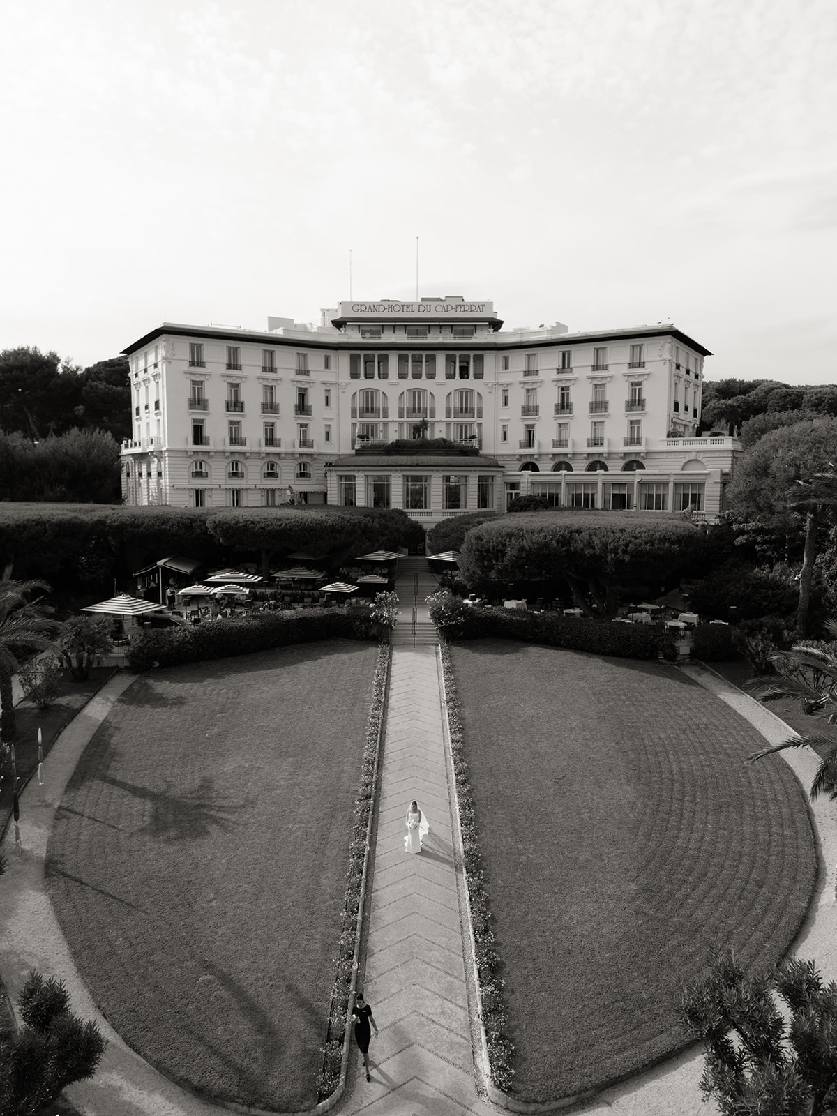 Drone view of a bride walking in front of the Grand-Hôtel du Cap-Ferrat on the French Riviera