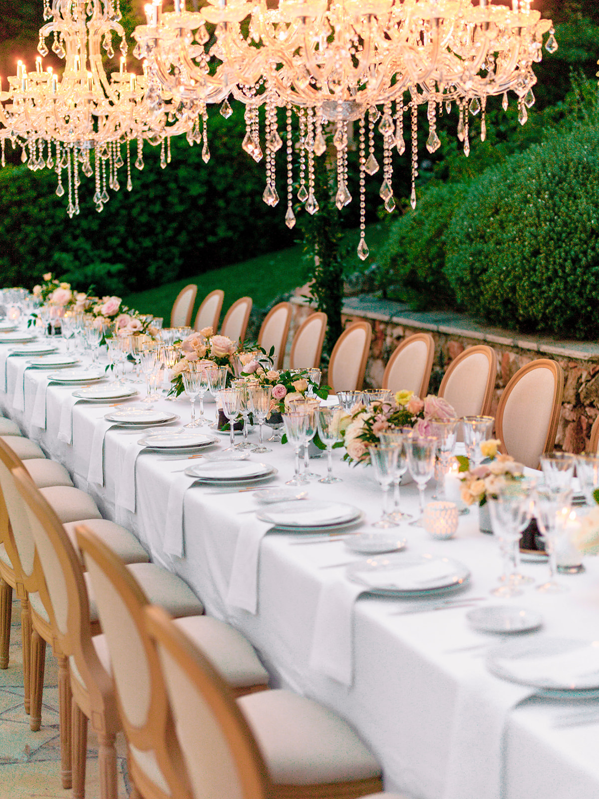Elegant long reception table beneath chandeliers at a Grand-Hôtel du Cap-Ferrat wedding