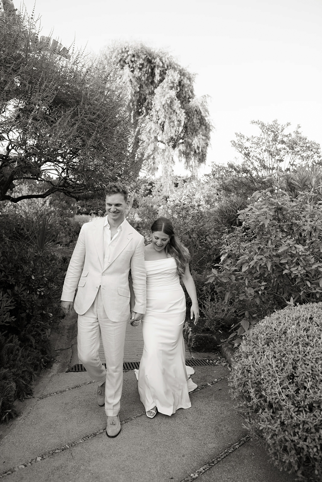 Black-and-white wedding couple walking through the gardens at Grand-Hôtel du Cap-Ferrat