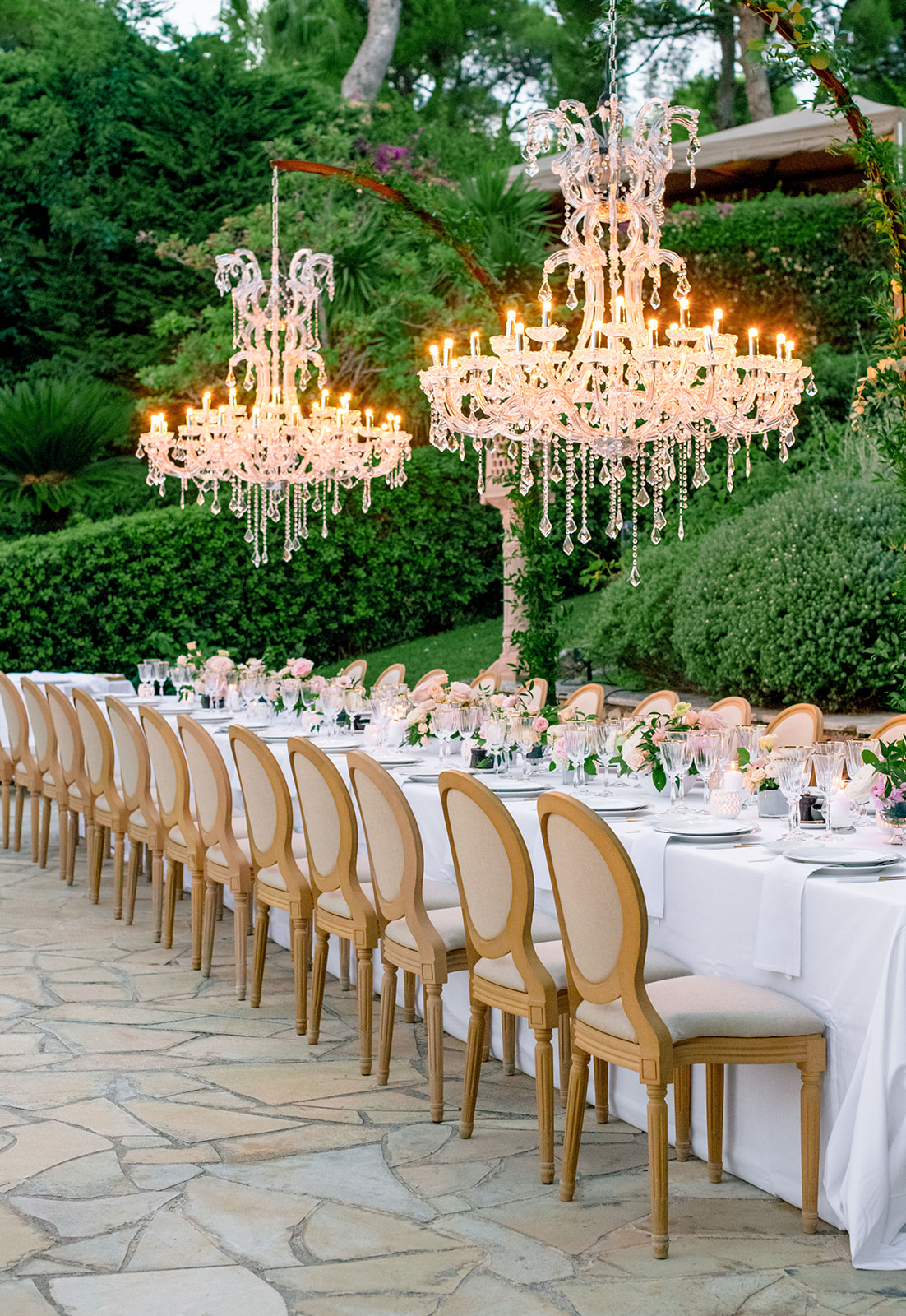 Long wedding dinner table with crystal chandeliers in the gardens of Grand-Hôtel du Cap-Ferrat
