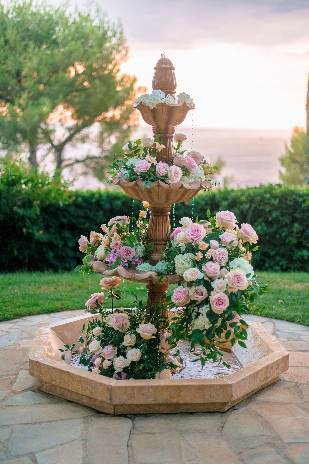 Floral wedding installation around a fountain overlooking the Mediterranean at Cap-Ferrat