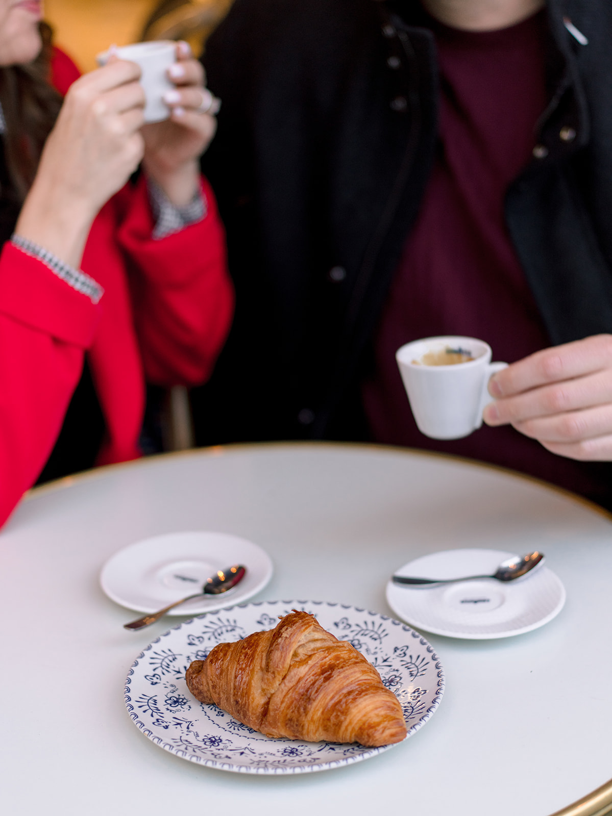 Croissant and espresso during an American couple photoshoot at a Paris café