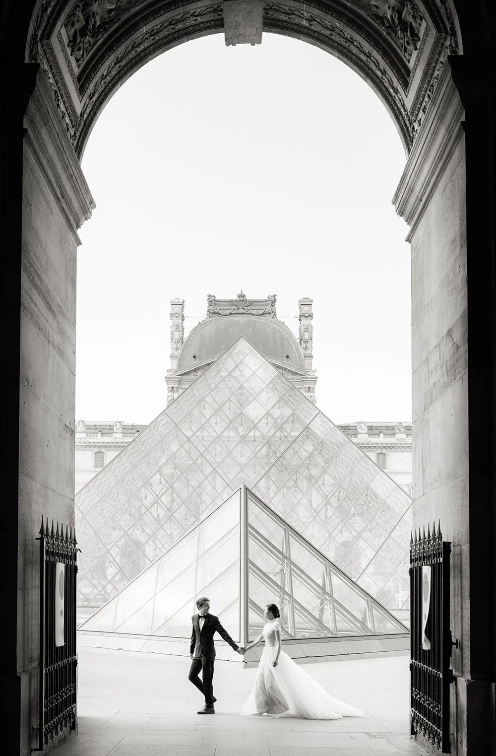 Bride and groom photographed in the Louvre courtyard