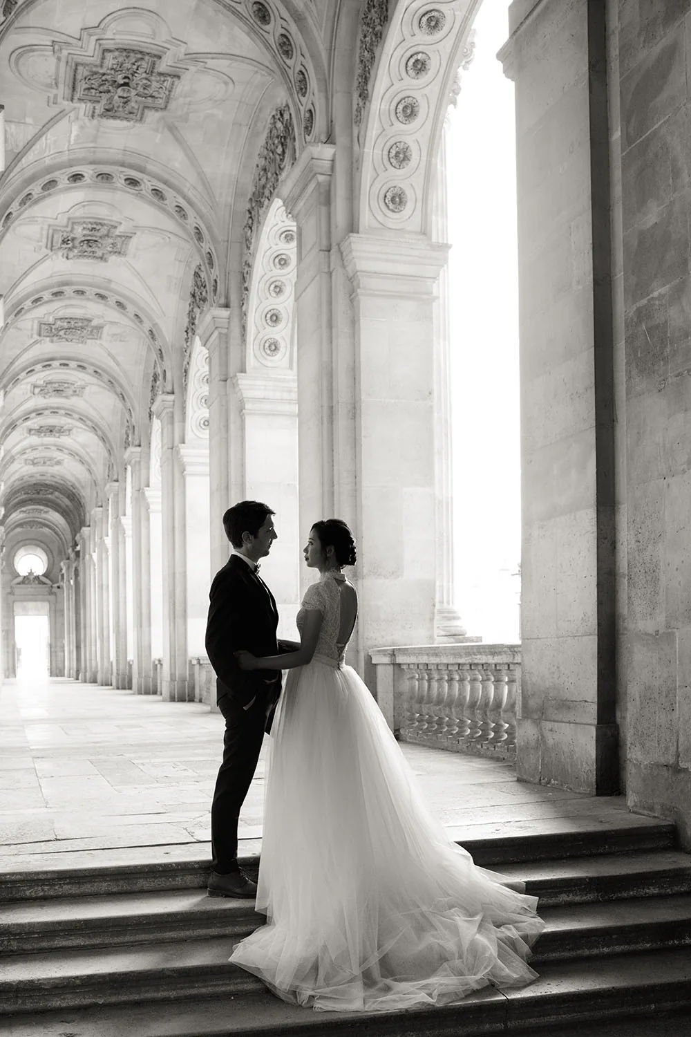 Bride photographed beneath the Louvre architecture