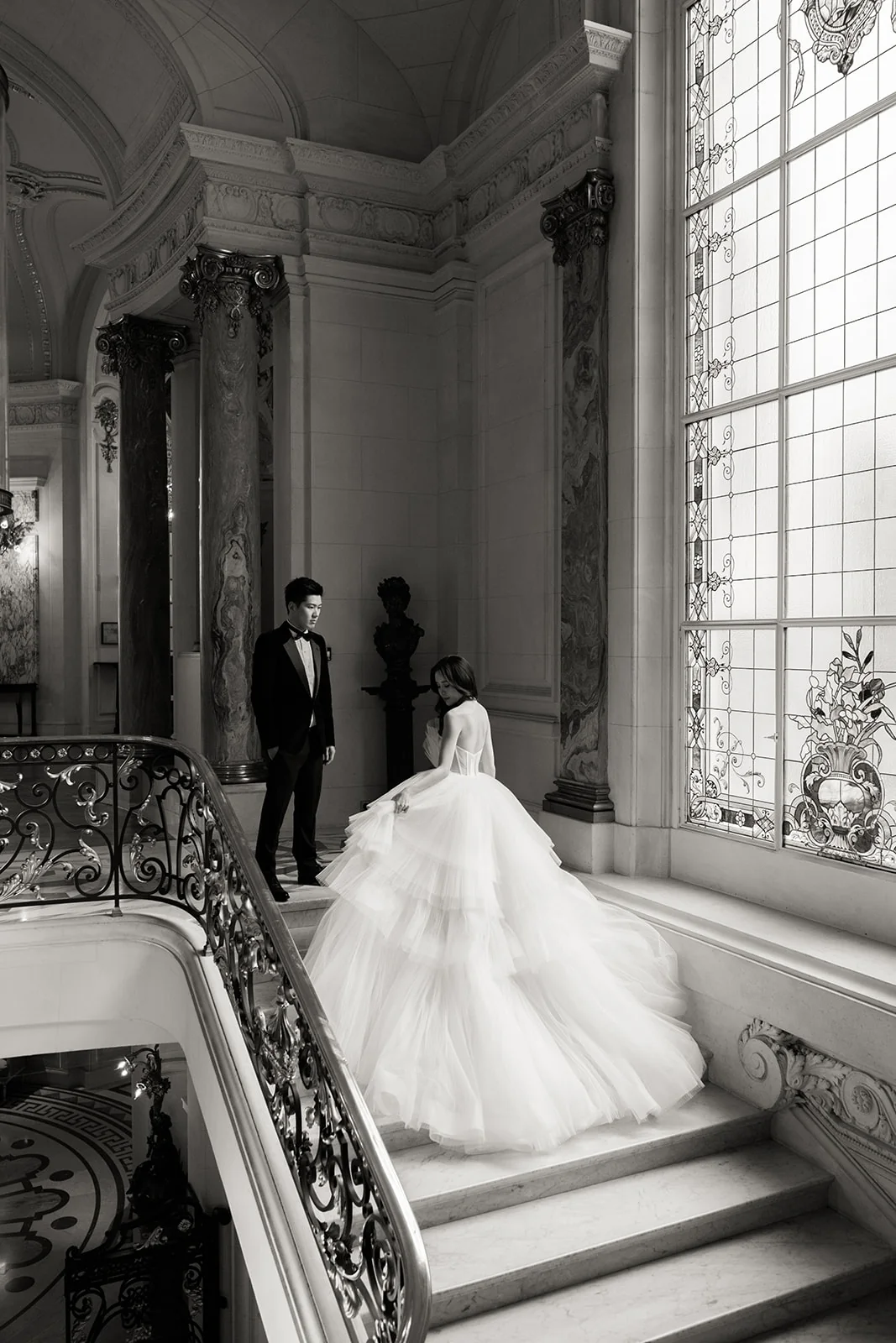 Couple on the grand staircase during a pre-wedding session at Shangri-La Paris
