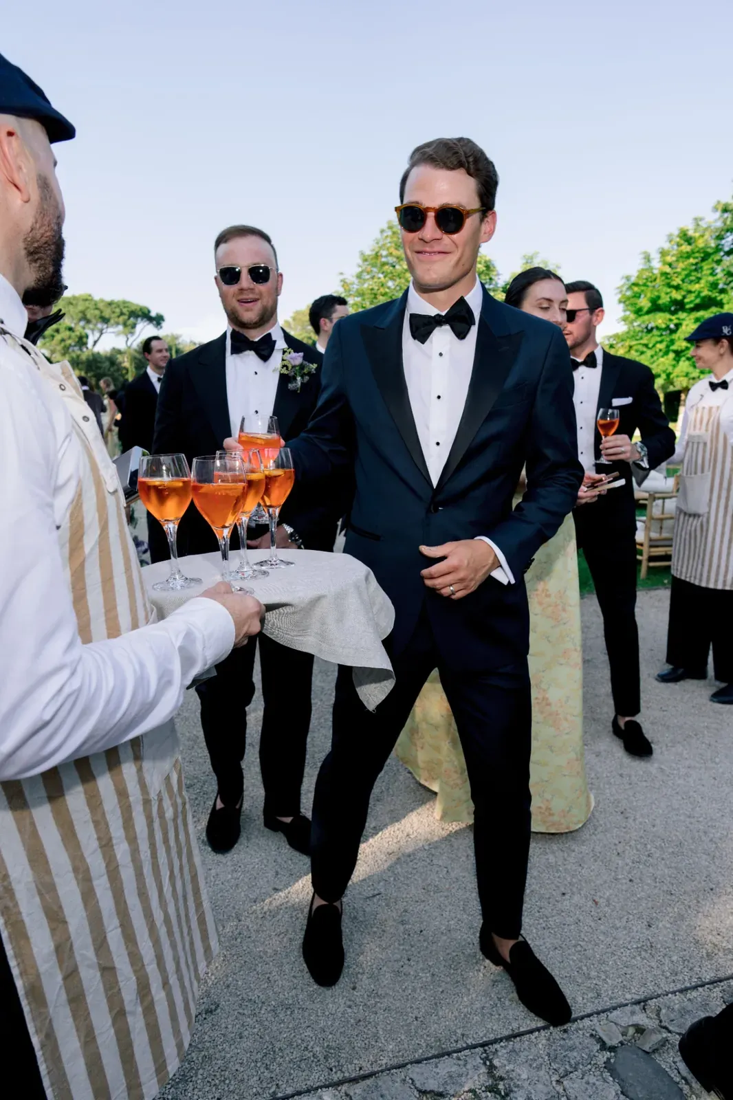 Groom taking an aperitif during cocktail hour at the Villa Baulieu wedding