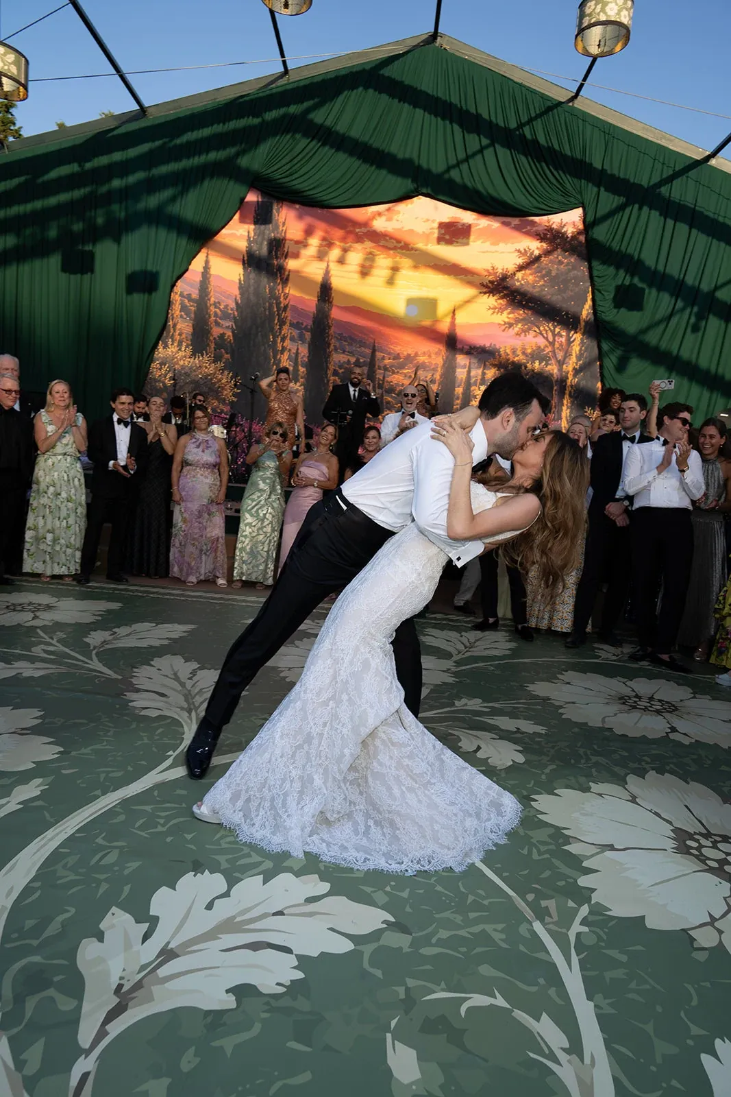 Bride and groom sharing a dramatic dip kiss during their first dance at Villa Baulieu