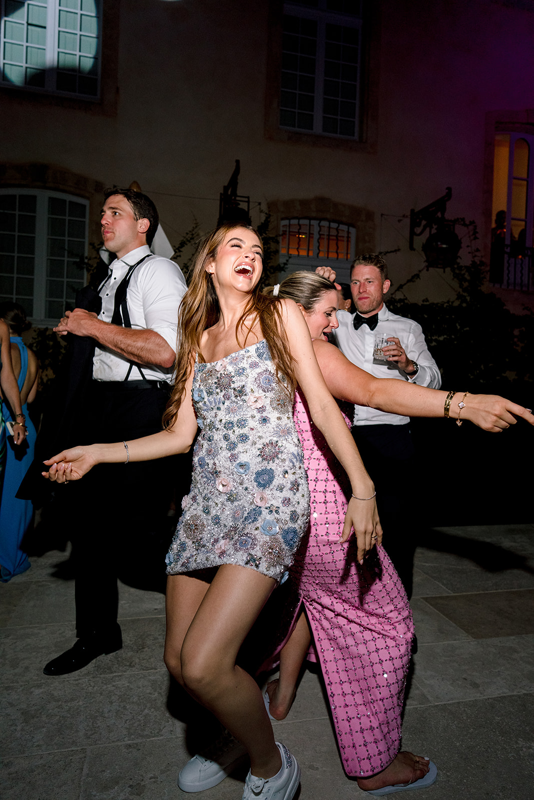 Bride and guests dancing at a late-night wedding after-party