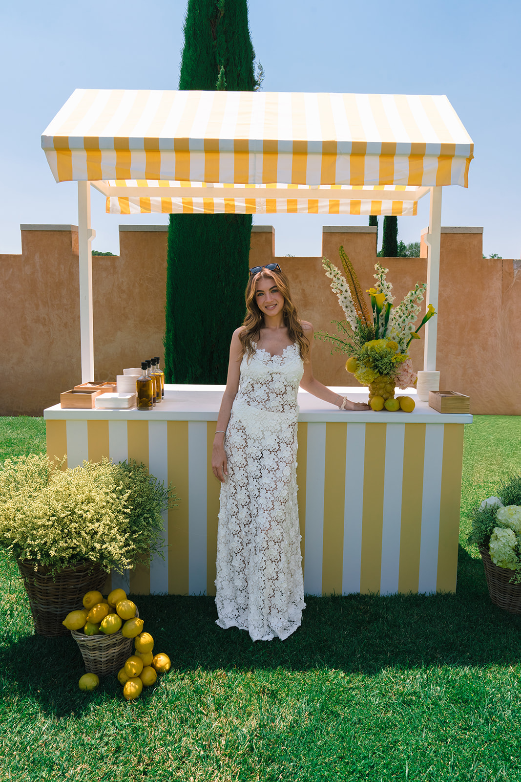 Bride at the lemonade bar during the Villa Baulieu pool party