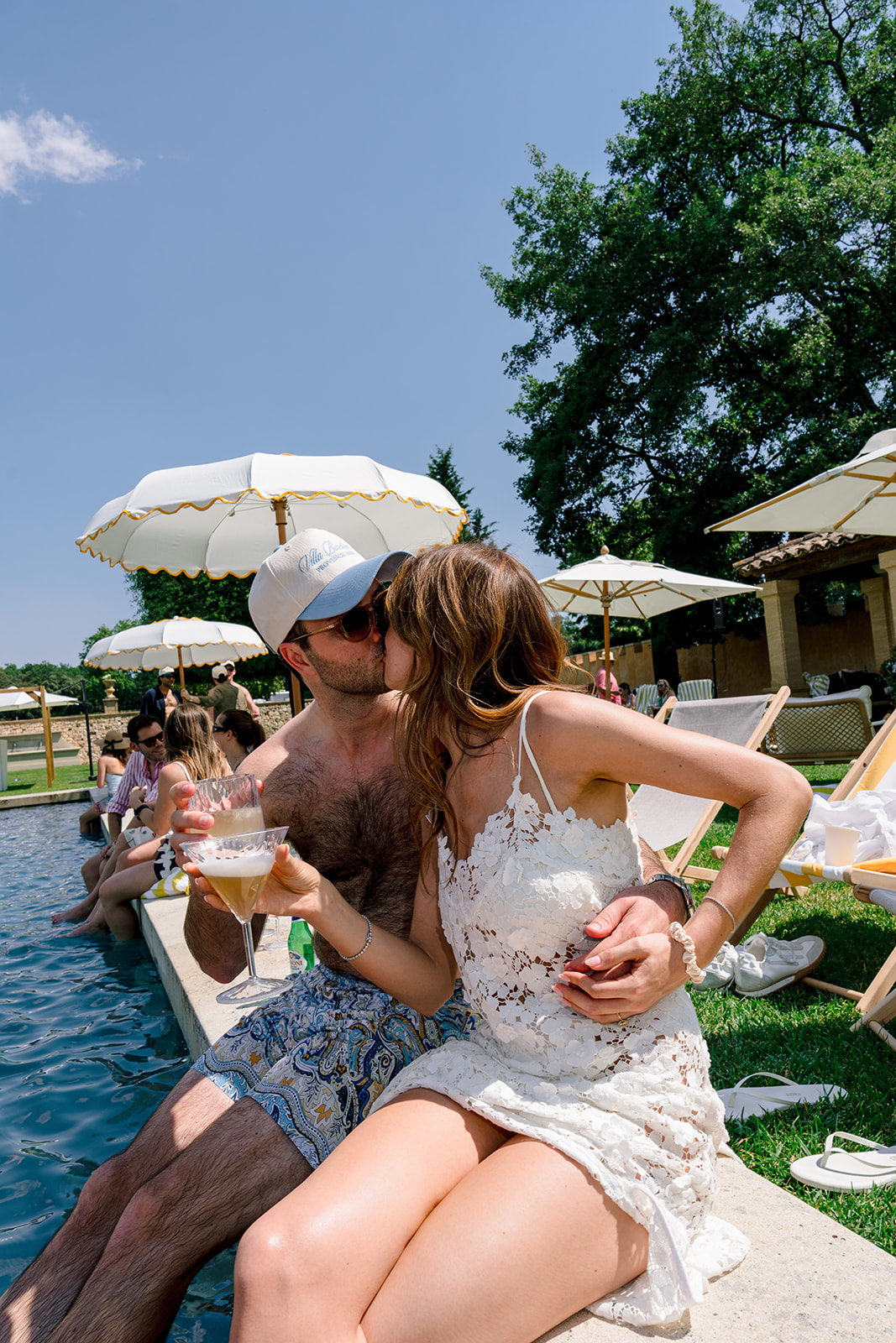 Couple sharing a poolside kiss during the Villa Baulieu pre-wedding party