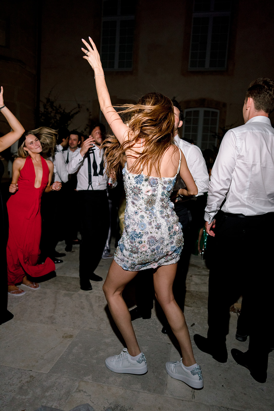 Wedding guest dancing in an embellished mini dress at Villa Baulieu