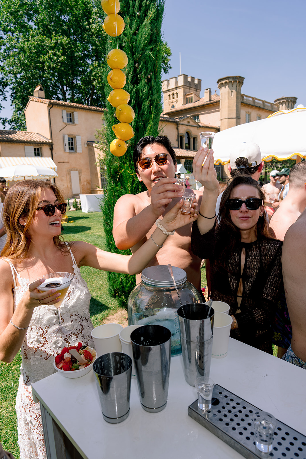 Guests raising shot glasses during the Villa Baulieu pool party in Provence