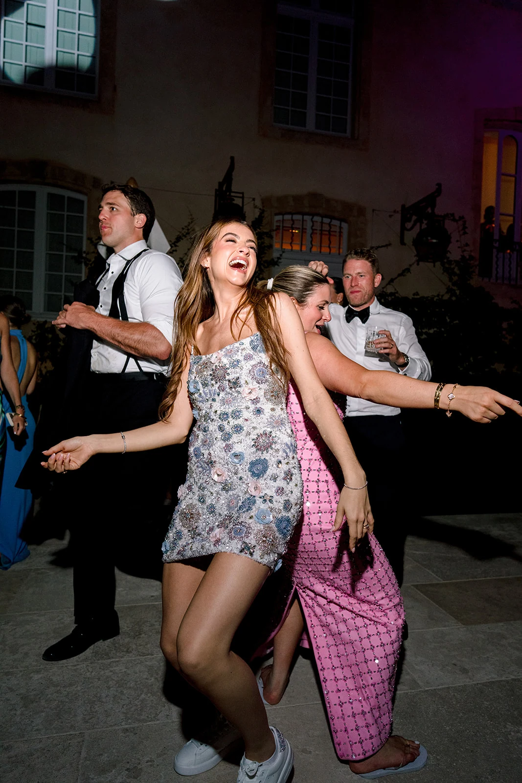 Bride and guests dancing at a late-night wedding after-party