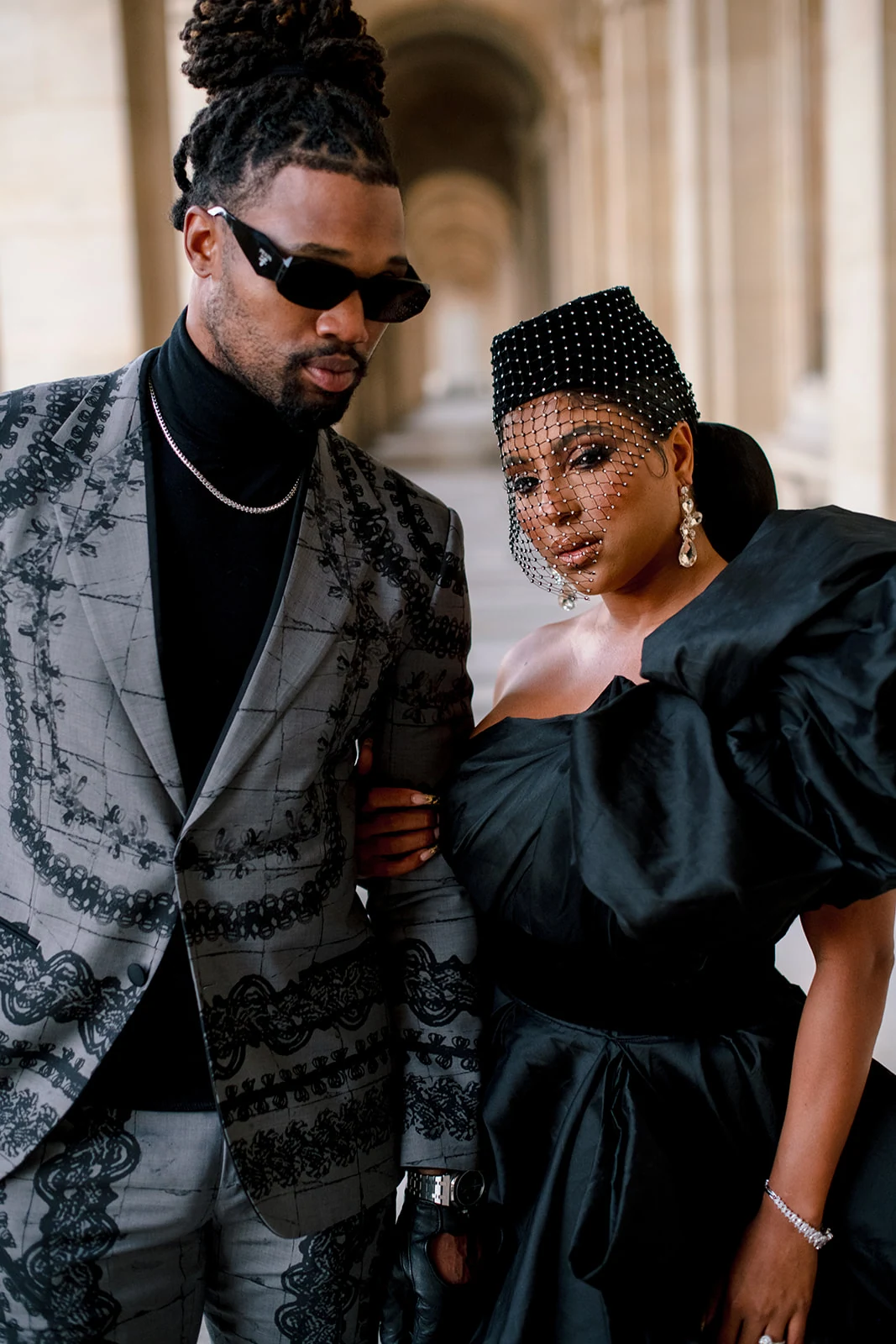 Close editorial portrait of Candice Craig and Omar Bolden in coordinated fashion looks