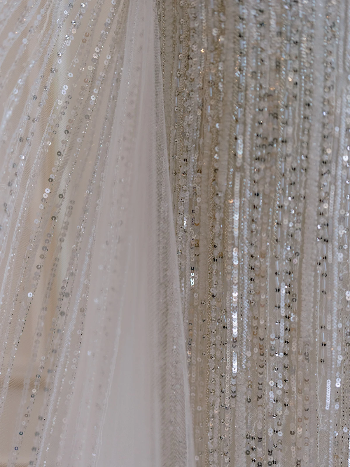 Close-up of crystal beading and sequins on a couture wedding dress in Paris