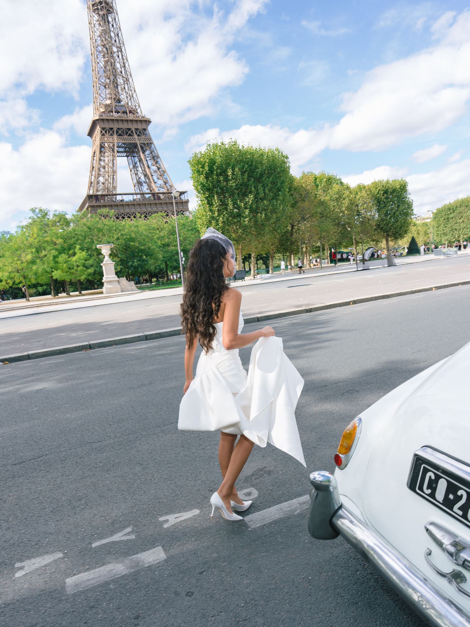 Bride photographed by the Eiffel Tower in an editorial Paris wedding portrait