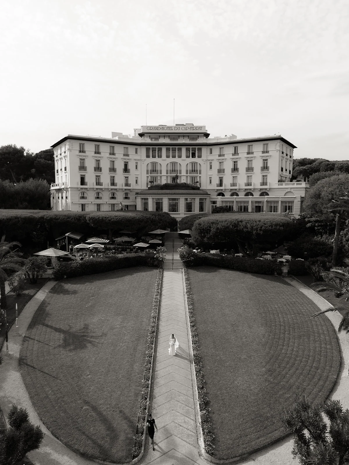 Drone view of a bride walking in front of the Grand-Hôtel du Cap-Ferrat on the French Riviera