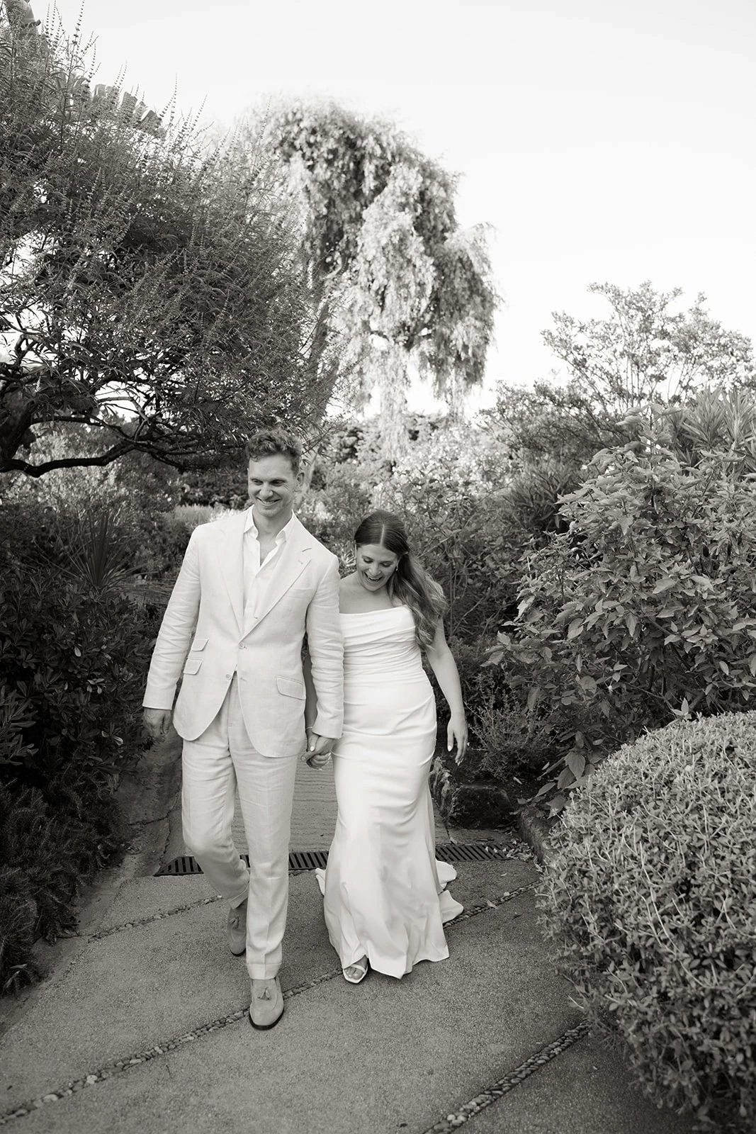 Black-and-white wedding couple walking through the gardens at Grand-Hôtel du Cap-Ferrat