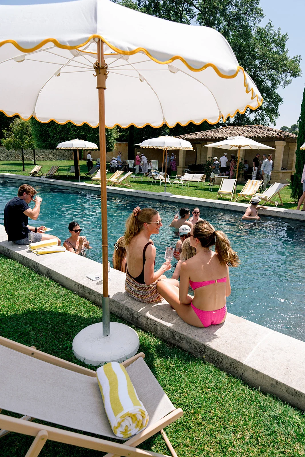 Wedding guests relaxing beside the pool during a destination wedding in Provence