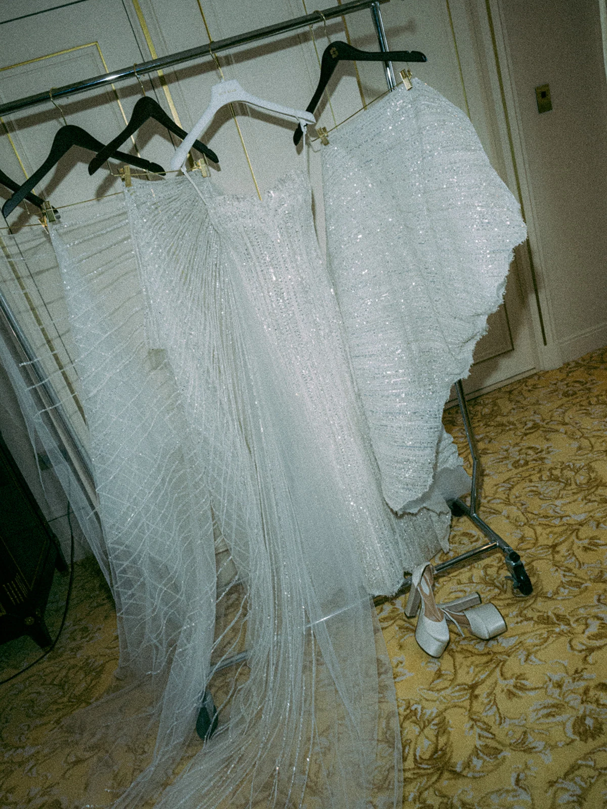 Embellished wedding dresses and bridal shoes prepared before a Paris wedding